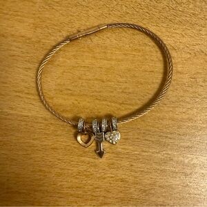 Gold tone metal cable bracelet with arrow heart love charms